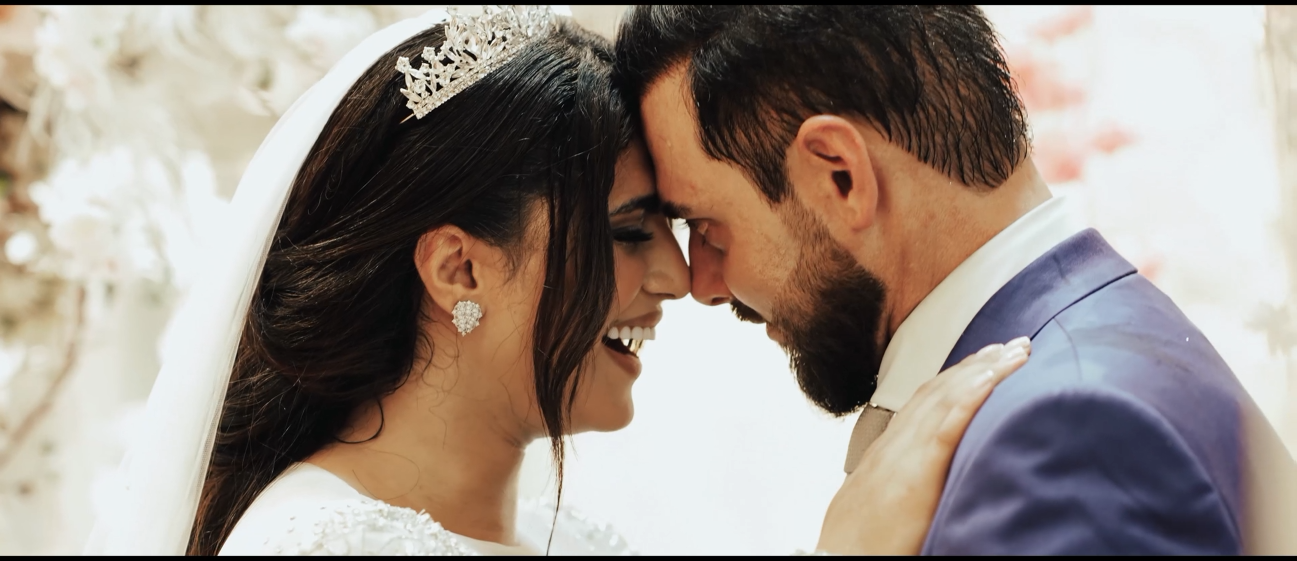 Bride and groom touching foreheads during their wedding celebration